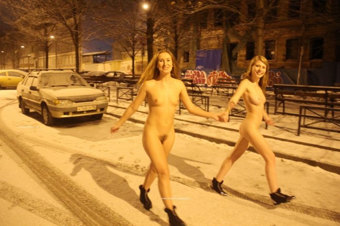 Two sexy ladies walks at winter streets