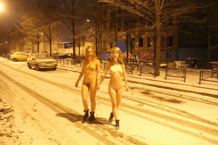 Two sexy ladies walks at winter streets