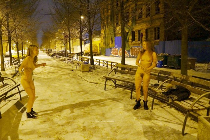 Two sexy ladies walks at winter streets