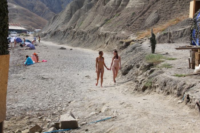 Two very hot teens walks naked at the beach
