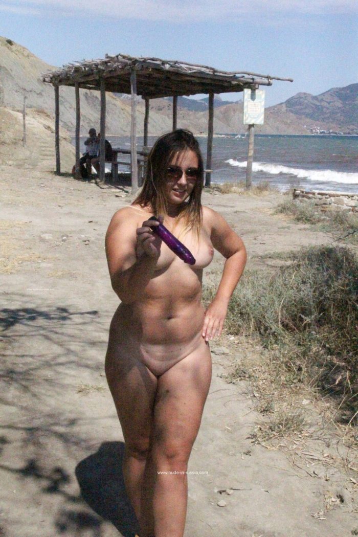 Fatty girl Nastia walks with dildo on the beach