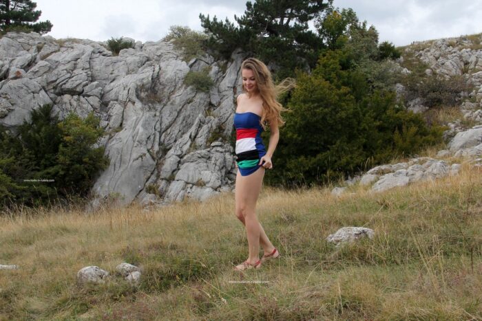 Lovely teen blonde Anna B walks naked outdoors