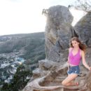 Naked blonde Anna B undresses on the rock
