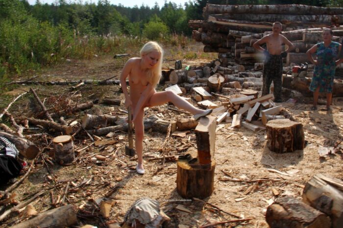 Naked teen Maria chopping wood