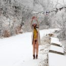 Smiling girl Alisha walks naked at very cold weather