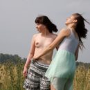 Two girls posing naked outdoors near car