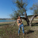 Aphrodesia stunningly poses her body outdoors as she strips out of her jeans and leather top.