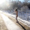 Brunette Klara wears only hat and stockings at winter road