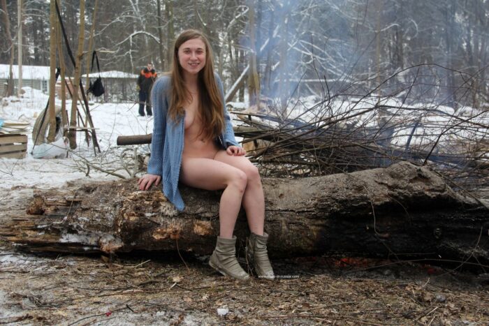 Busty teen Dana flashes her body by the winter fire