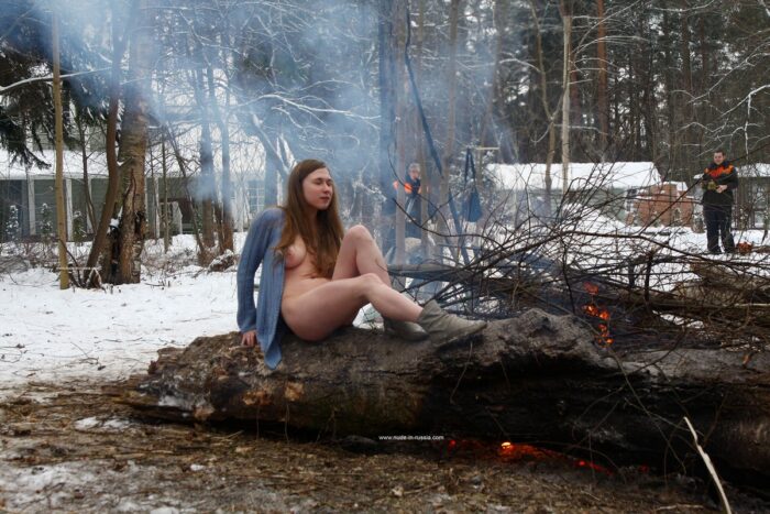 Busty teen Dana flashes her body by the winter fire