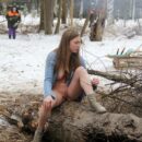 Busty teen Dana flashes her body by the winter fire