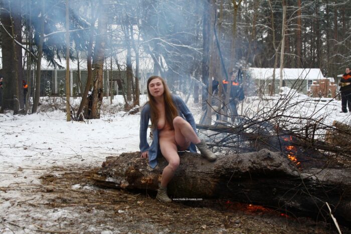 Busty teen Dana flashes her body by the winter fire