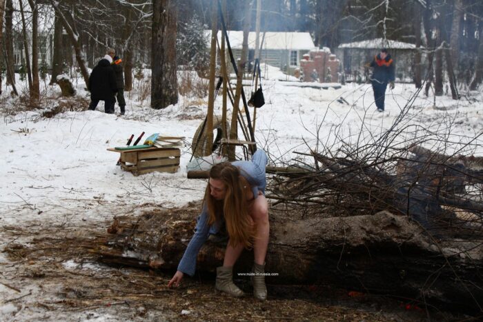 Busty teen Dana flashes her body by the winter fire