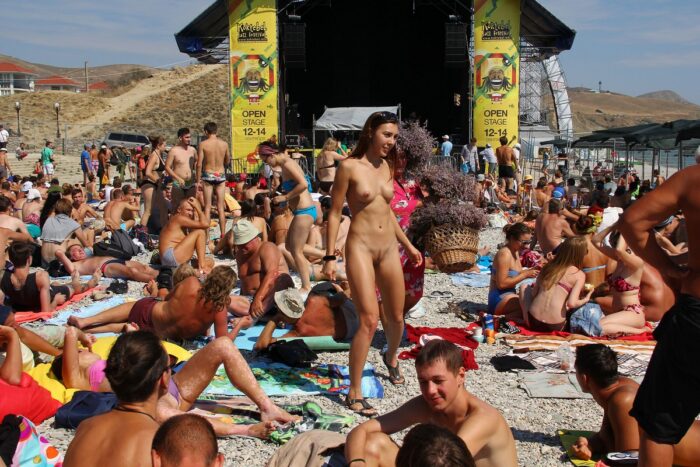 Really shameless teen Jana A walks naked at public beach