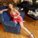 Stella Flex sultrily slips off her coral dress while chilling out on the couch. She stretches her sexy body and show off her kitty.