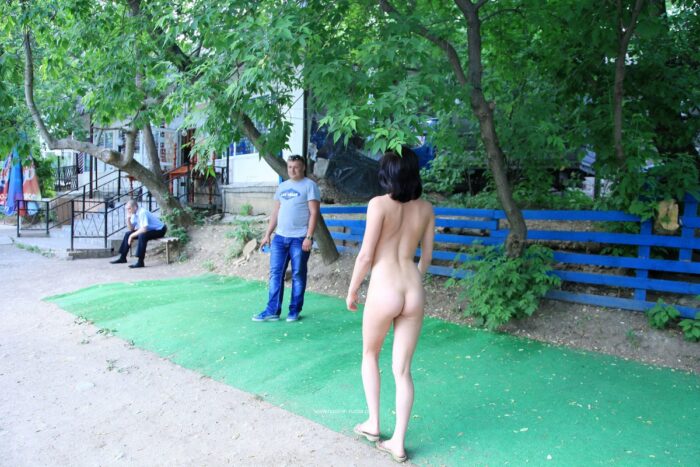 Totally naked brunette taking pictures with two strangers