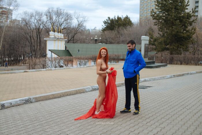 Absolutely naked Nata posing with red handkerchief at public park