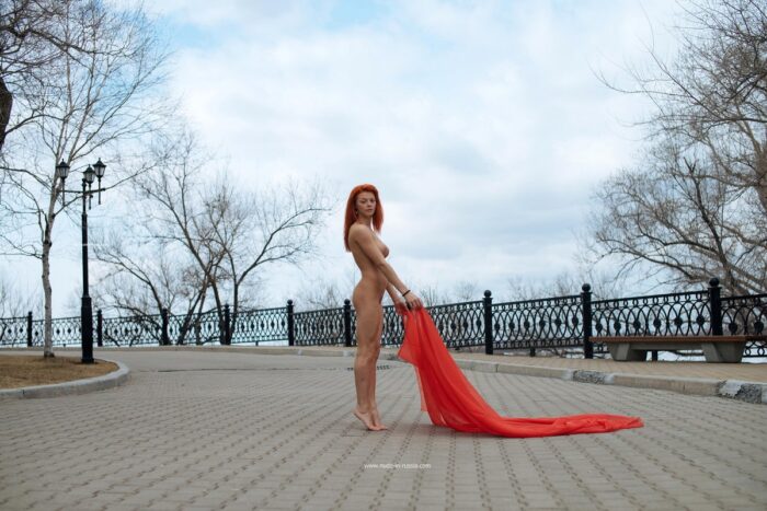 Absolutely naked Nata posing with red handkerchief at public park
