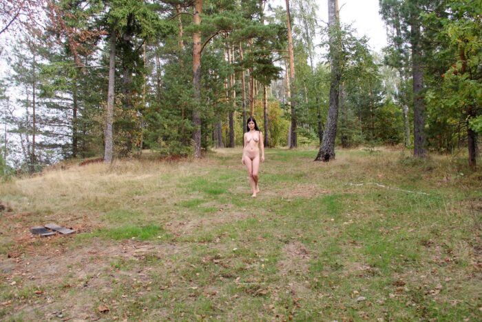 Brunette Kat walks naked at forest