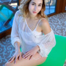 Curly haired Margaret Clay extends her long legs and sexy arms over the yoga mat. She takes off her white leotards and holds out her perky knockers and pinkish spank-ready buns.