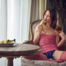 Pretty Nedda A eats a banana while lounging on the chair by the window. She puts it down and shows off her slim sexy figure then sticks her finger inside her hairless muff.