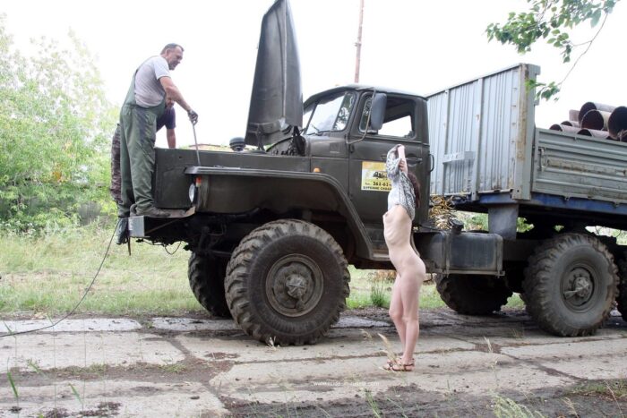 Russian girl Inga undresses in front of the mechanics