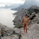 Russian teen Nasiba Z shows her very hairy pussy on the rocks