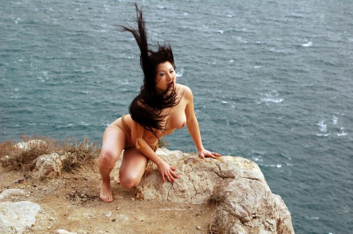 Sexy brunette Sveta O posing on very windy rocks