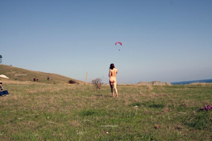 Smiling teen Jana A undresses in front of the parachutists