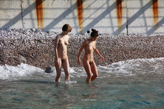 Two girls swim in the sea in the morning
