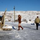 Two russian girls sledding in very cold weather