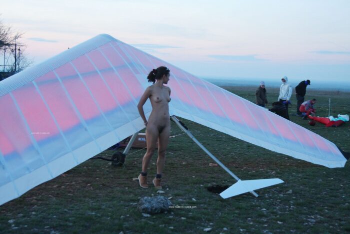 Young russian Nasiba Z near paraglider at evening