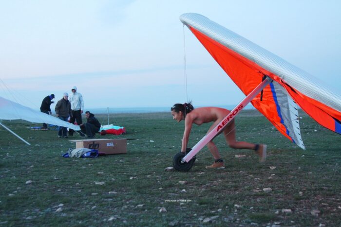 Young russian Nasiba Z near paraglider at evening