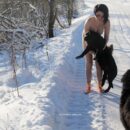Naked brunette Klara only in bright socks posing with dogs