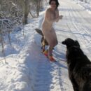 Naked brunette Klara only in bright socks posing with dogs