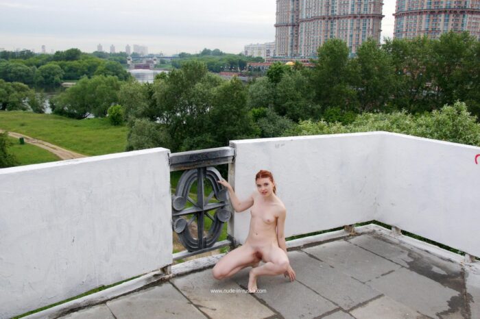 Redheaded teen Orabelle A shows pussy on public bridge