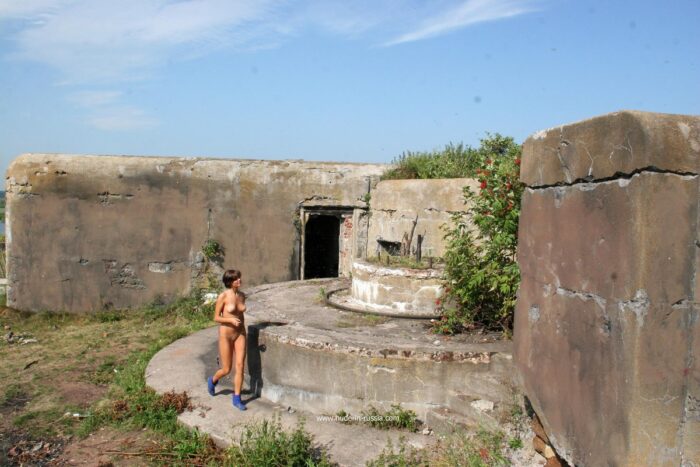 Short-haired Anna S removes pink panties at old fort