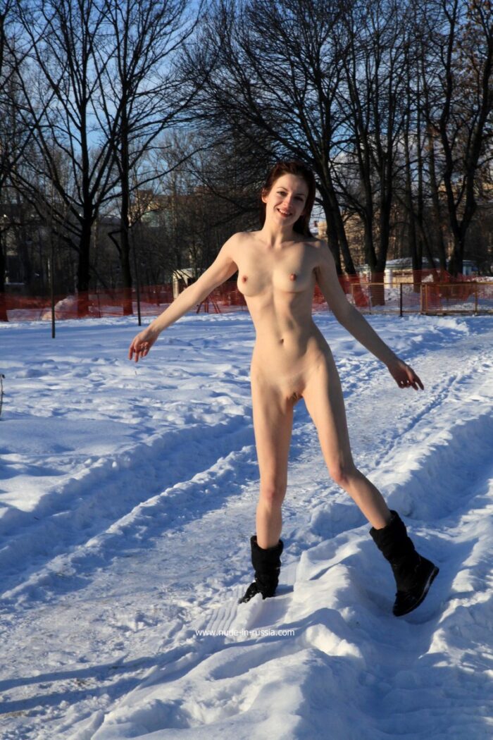 Slim girl Elisaveta posing only in boots in the snow