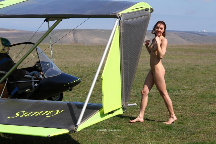 Very sexy girl Jana A posing next to a small plane