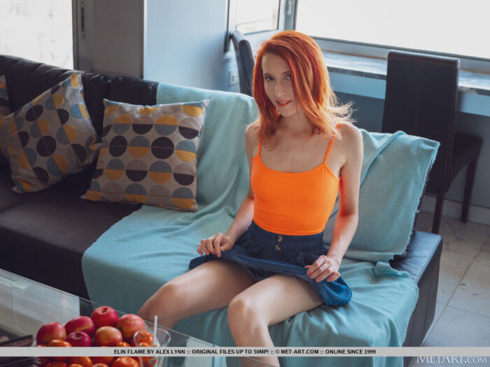 Beautiful red hair Elin Flame ravishingly bends over and expose her sexy butt and takes off her orange shirt and lifts her toes up to give an open view to her fat pussy.