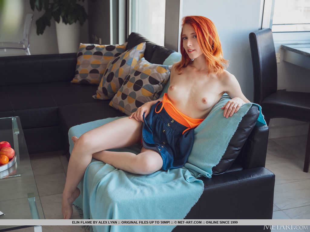 Beautiful red hair Elin Flame ravishingly bends over and expose her sexy butt and takes off her orange shirt and lifts her toes up to give an open view to her fat pussy.