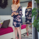Beautiful red haired Elin Flame looks in the mirror as she lifts the hem of her dress and expose her  hairless pussy.