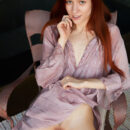 Beautiful red haired Sherice strip naked on the chair and uncover her petite sexy figure and hairless pussy.