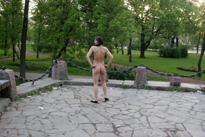 Naked brunette Polina in a city park