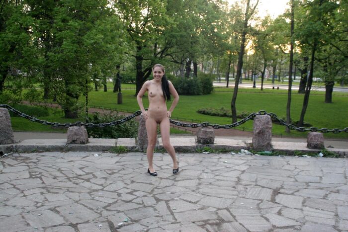 Naked brunette Polina in a city park
