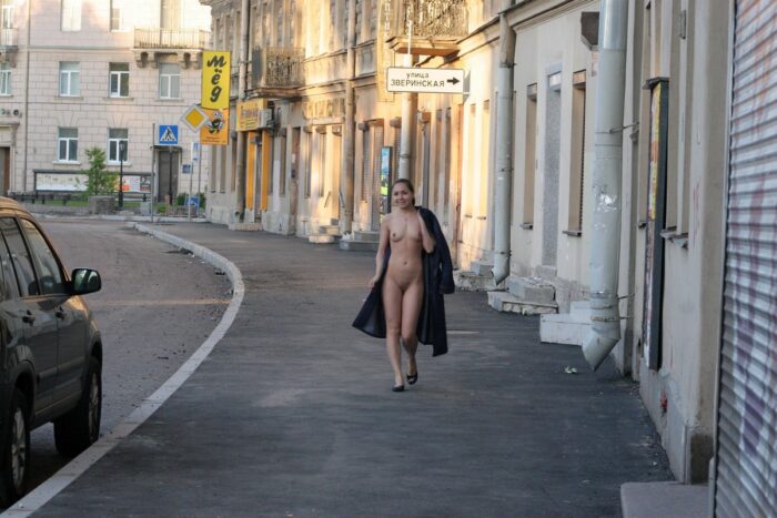Russian brunette Polina walks naked at city center