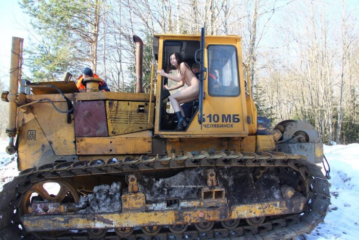 Teen brunette Lera with small tits on an excavator