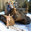 Teen brunette Lera with small tits on an excavator