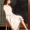 This seductive maiden naughtily lifts the hem of her dress, revealing her smooth legs, cute butt and shaved pussy before fully stripping naked.