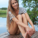 The beautiful Lina Diamond delivers a   gorgeous erotic outdoor shoot, strip   teasing her black and white stripe   shirt and poses on the dock by the   river.